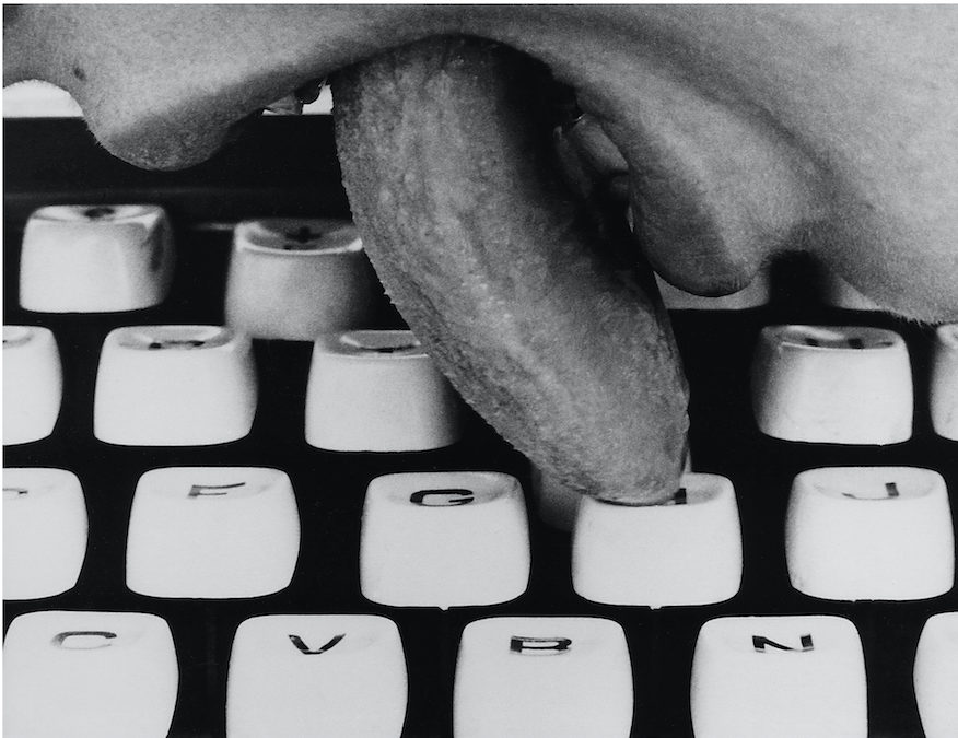 black and white image tounge licking keyboard