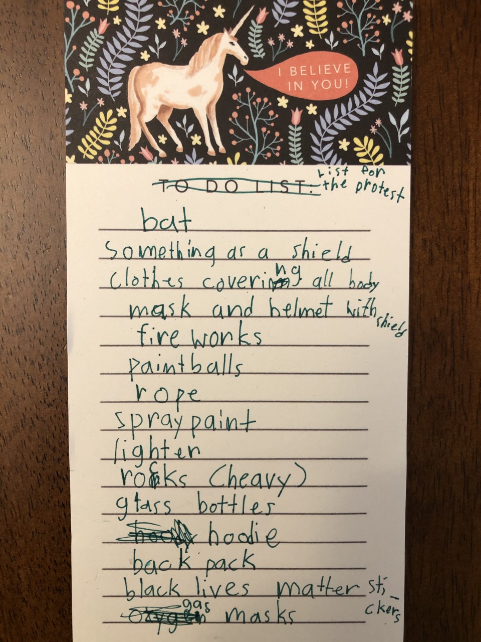 list written by child of items to bring for protest, including bat, rope, lighter