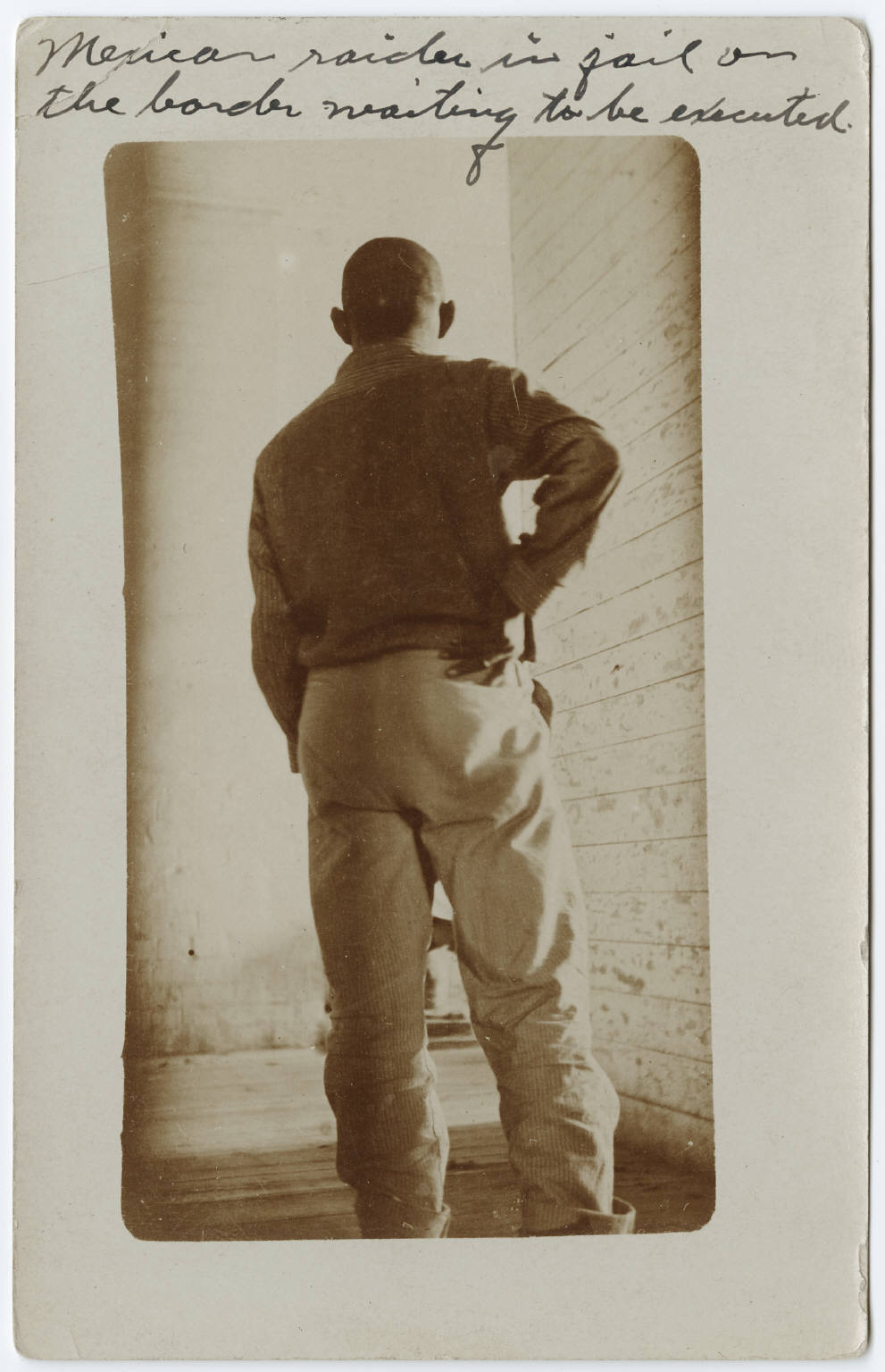 man standing facing away from camera